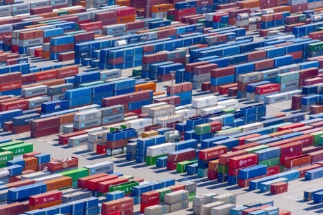 This is an image of hundreds of shipping containers of different colors with some bearing the name: “Maersk.”