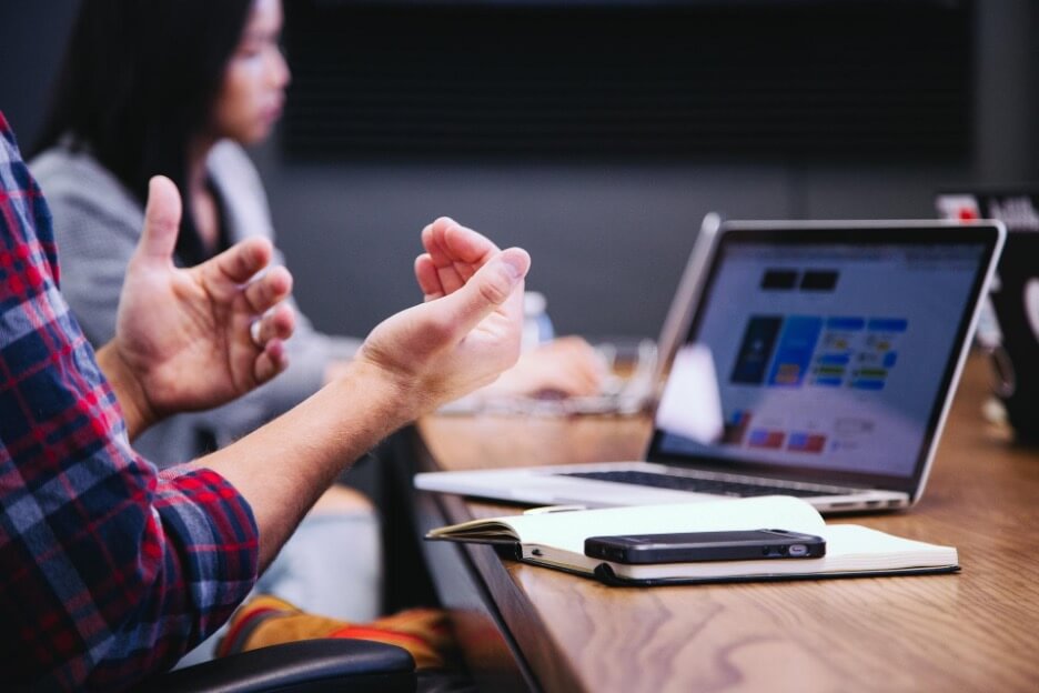 A social media marketer explains important information to a client.