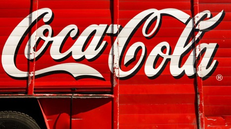 This is an image of a red truck with the Coca-Cola logo on the right side of it.