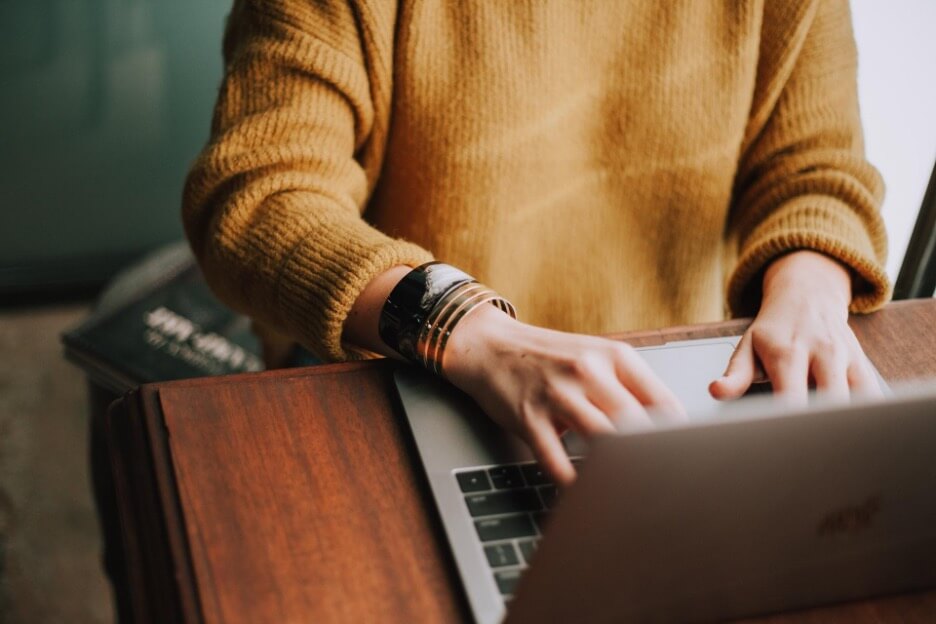 A social media marketer looks at her Macbook as she manages social media accounts for her clients.