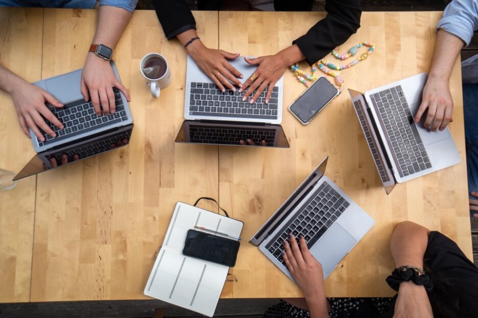 Five workers from a social media company discuss a project for a new client.