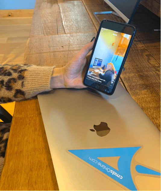  A woman’s hand holds a smartphone while she is watching a reel video from Instagram. 